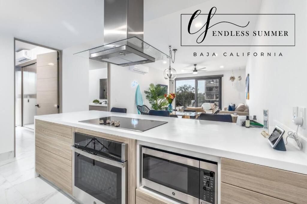 a kitchen with a sink and a stove top oven at Endless Summer - 2Bed 2Bath Condo - Seasonly Heated Pool with Ocean Views - 5min walk to Beach - Fibre Internet - Sleeps 6 in Cabo San Lucas
