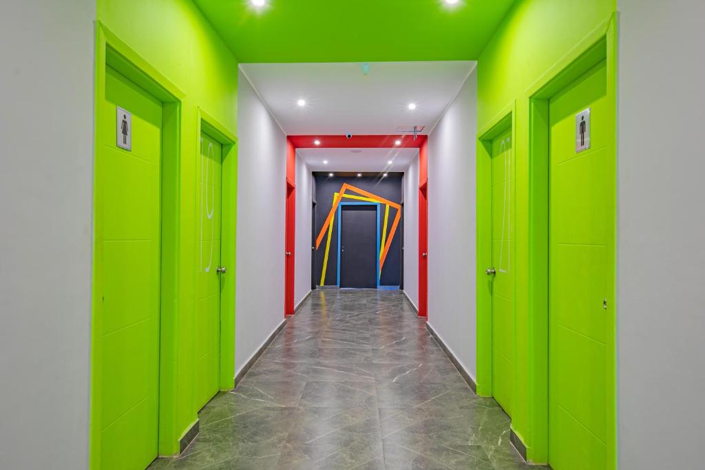 a hallway with green lockers and a colorful door at Bedcoin Hostel in Hurghada