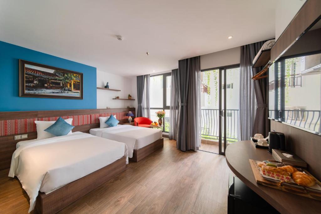 Postel nebo postele na pokoji v ubytování Aaron Boutique Hotel