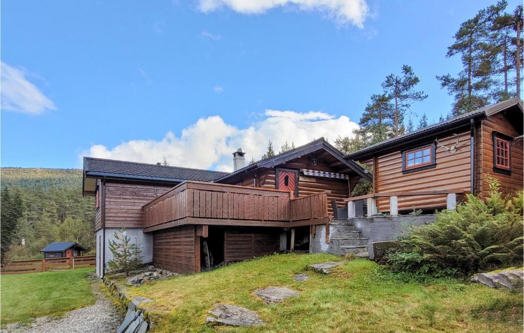 a log home with a deck on a hill at 3 Bedroom Stunning Home In Vossestrand in Vossestrand