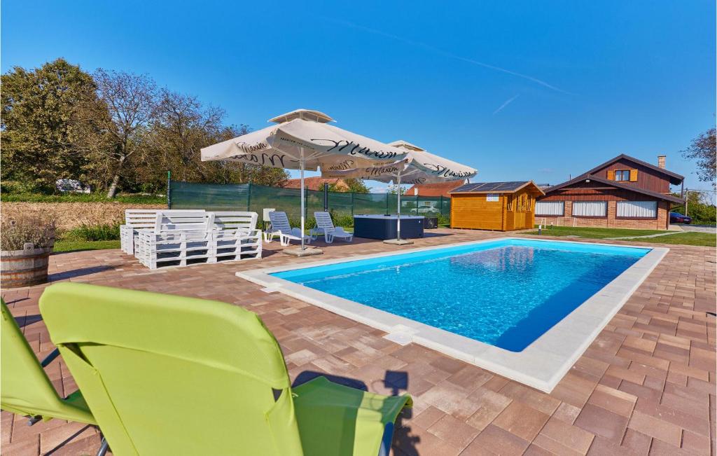 piscina con sedie e ombrellone di Nice Home In Kupinovac With Kitchen 