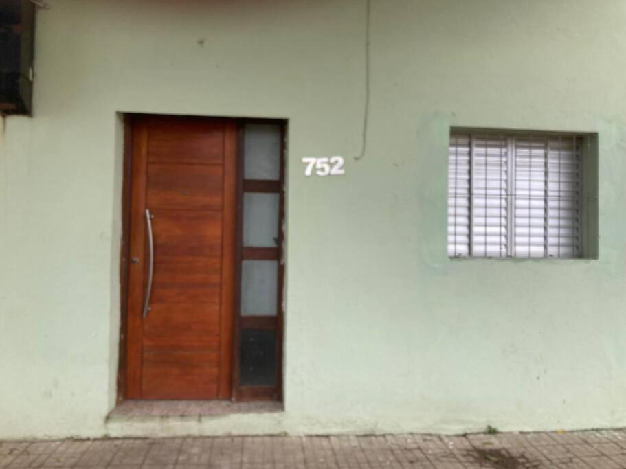 a wooden door on the side of a building at Casa centrica! in Artigas