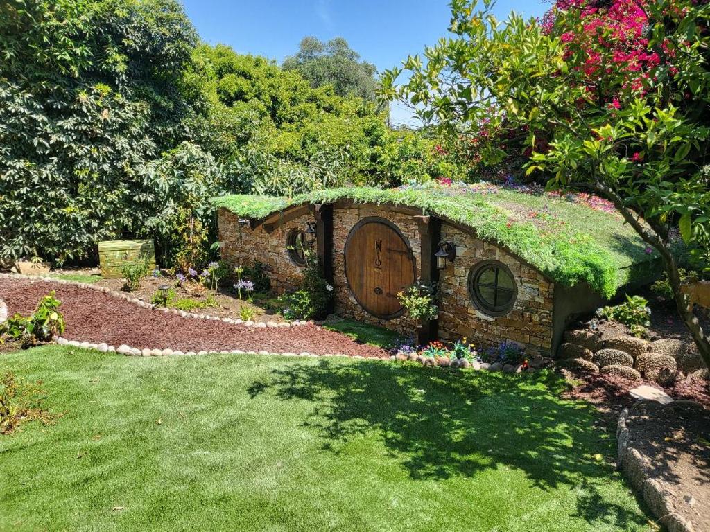 a garden with a house with a green roof at Hobbit Haven in Santa Barbara