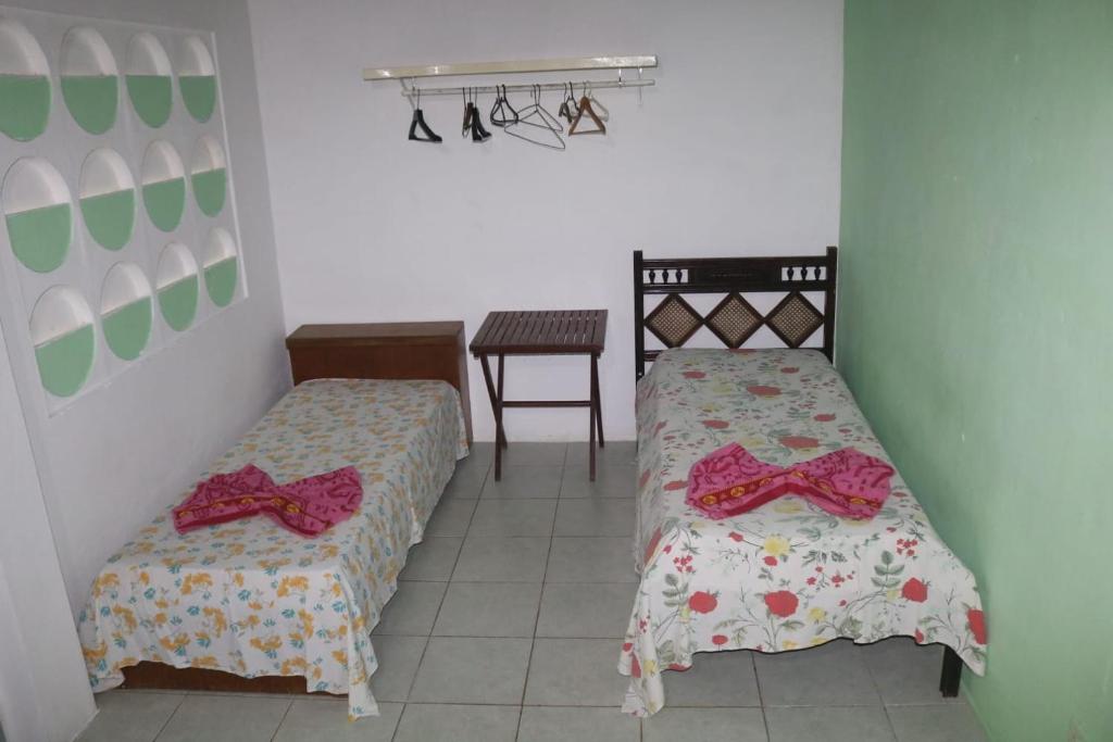 Postel nebo postele na pokoji v ubytování Casa de Temporada das Mangueiras
