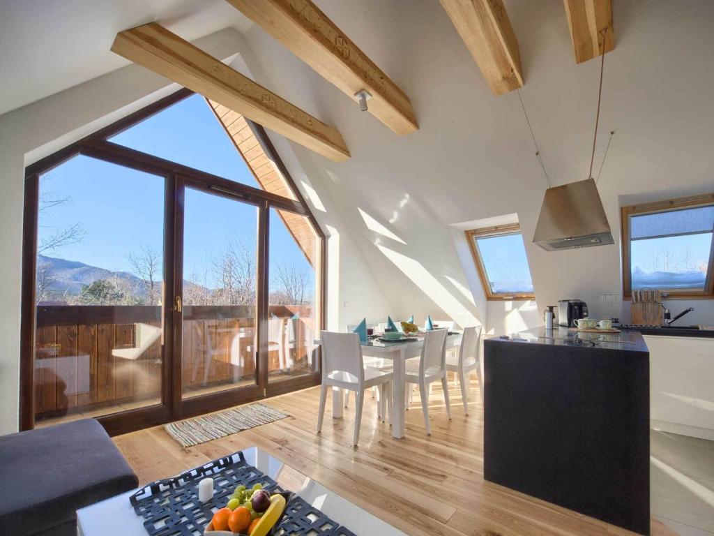 a kitchen and living room with a table and chairs at VisitZakopane - Superior Apartment in Zakopane