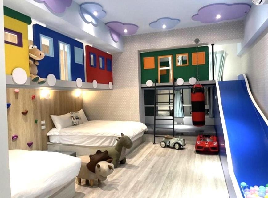 ein Schlafzimmer mit 2 Betten und einer Rutsche in der Unterkunft 屏東潮州民宿-綠品文旅Green Inn in Chaozhou