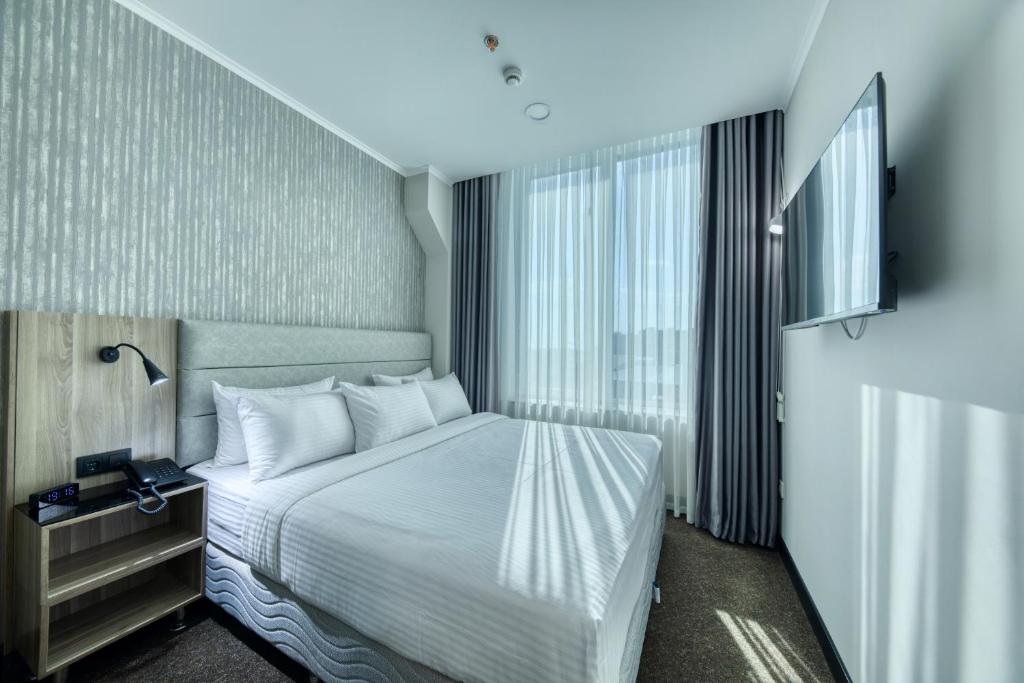 Ένα ή περισσότερα κρεβάτια σε δωμάτιο στο Expocore Hotel