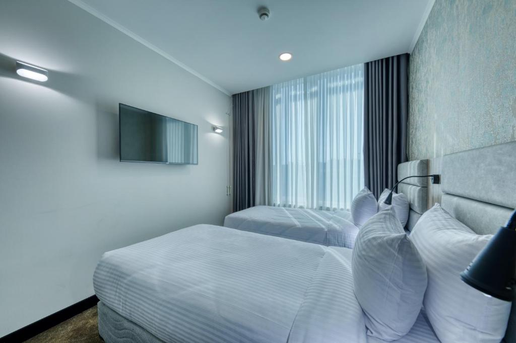 Postel nebo postele na pokoji v ubytování Expocore Hotel
