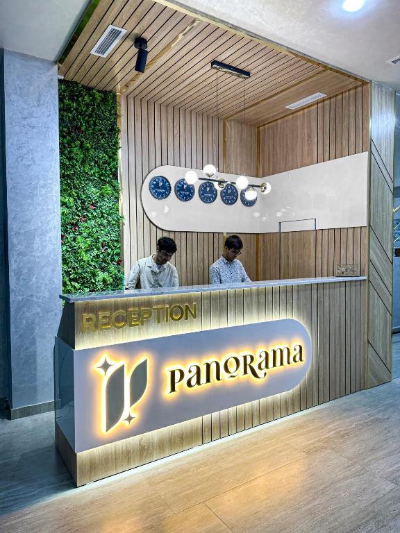 two men standing at a counter in a restaurant at Panorama Hotel & More in Samarkand