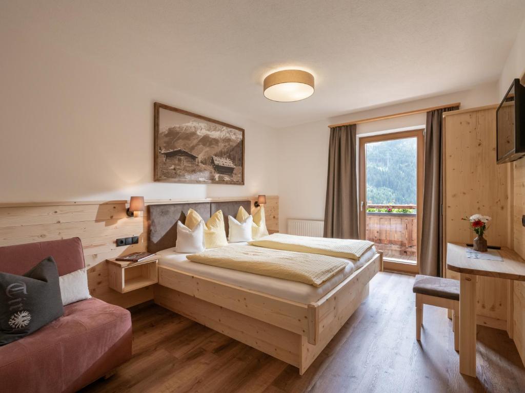 a hotel room with a bed and a couch at Landhaus Christina in Brandberg