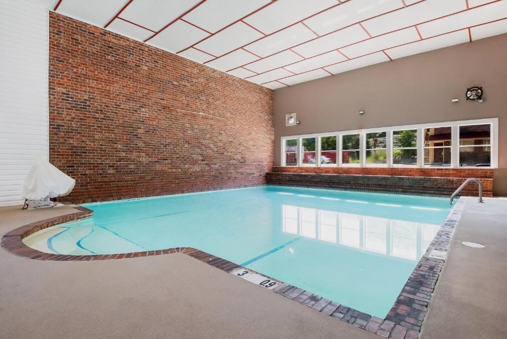 a large indoor swimming pool with a brick wall at Red Roof Inn Chattanooga - Lookout Mountain in Chattanooga