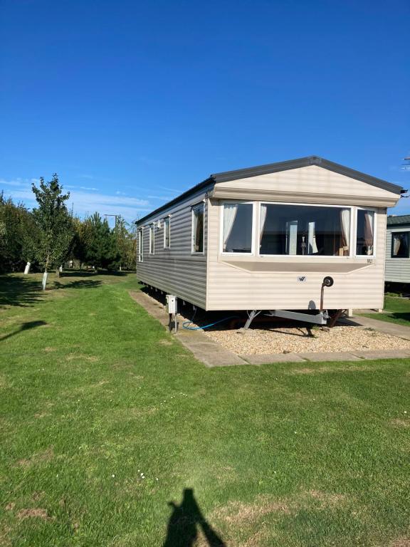 a shadow of a person standing in front of a caravan at Golden palm in Chapel Saint Leonards