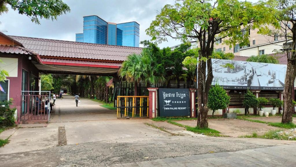 a walkway over a street in a city with buildings at Twin Palms Resort in Sihanoukville
