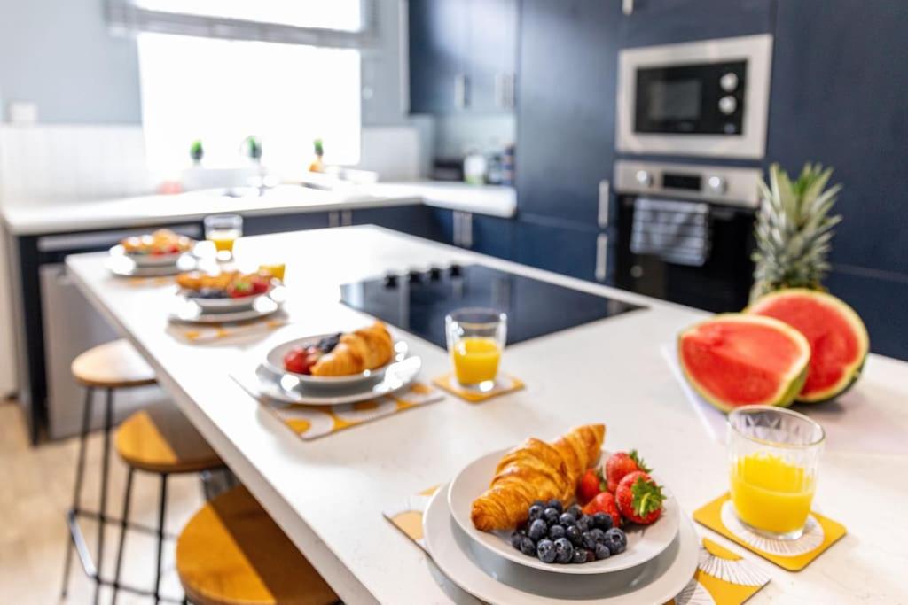 einen Frühstückstisch mit Obst, Croissants und Orangensaft in der Unterkunft Liquorice Lodge- 2 bed & parking in Castleford