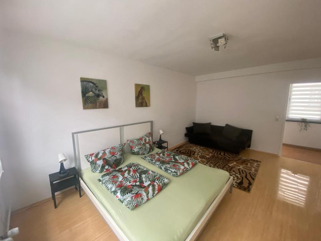 a bedroom with a bed with pillows on it at Chic & Trendy Mainz Apartment near cetral station in Mainz