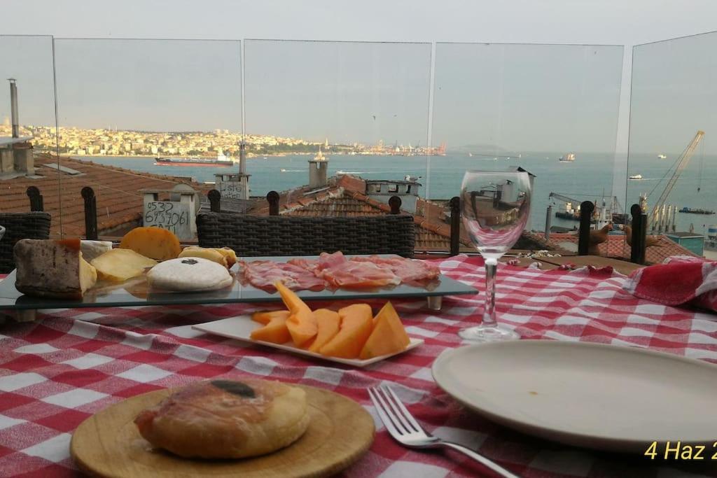 a table with a plate of food and a glass of wine at Bosphorus&Topkapi Place view-Airport shutle-Private parking in Istanbul