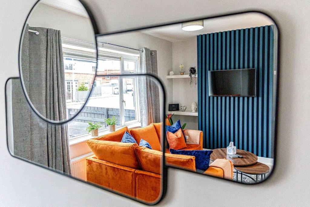 a mirror reflection of a living room with a couch at The Collier's Rest: 3 bed home in South Yorks with parking & garden. in Barnsley