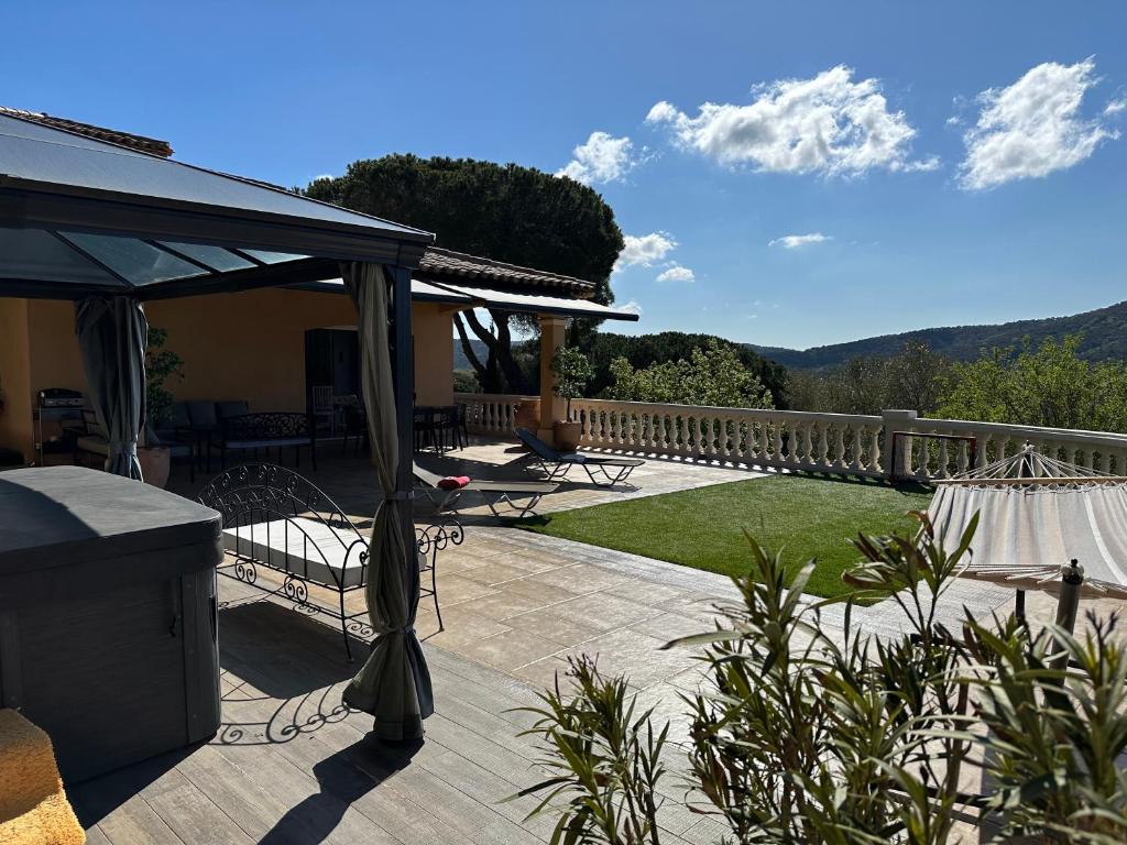 a patio with a view of the mountains at villa Pierre in Cogolin