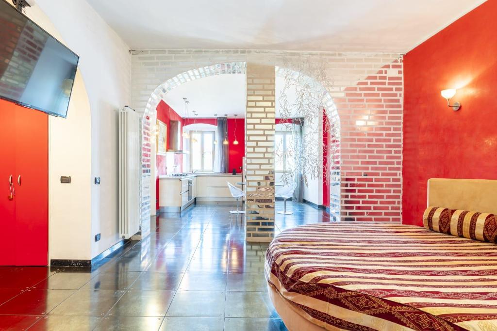 a bedroom with a bed and a red wall at Steel house in Livorno