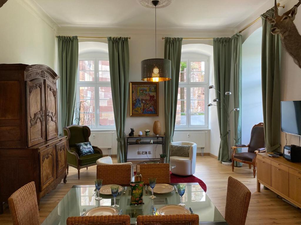 a living room with a table and chairs at Les Arches du Couvent - classé 5 étoiles in Marmoutier