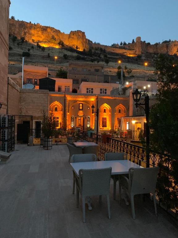 a patio with tables and chairs in front of a building at Mardin Konak Osmanlı in Mardin