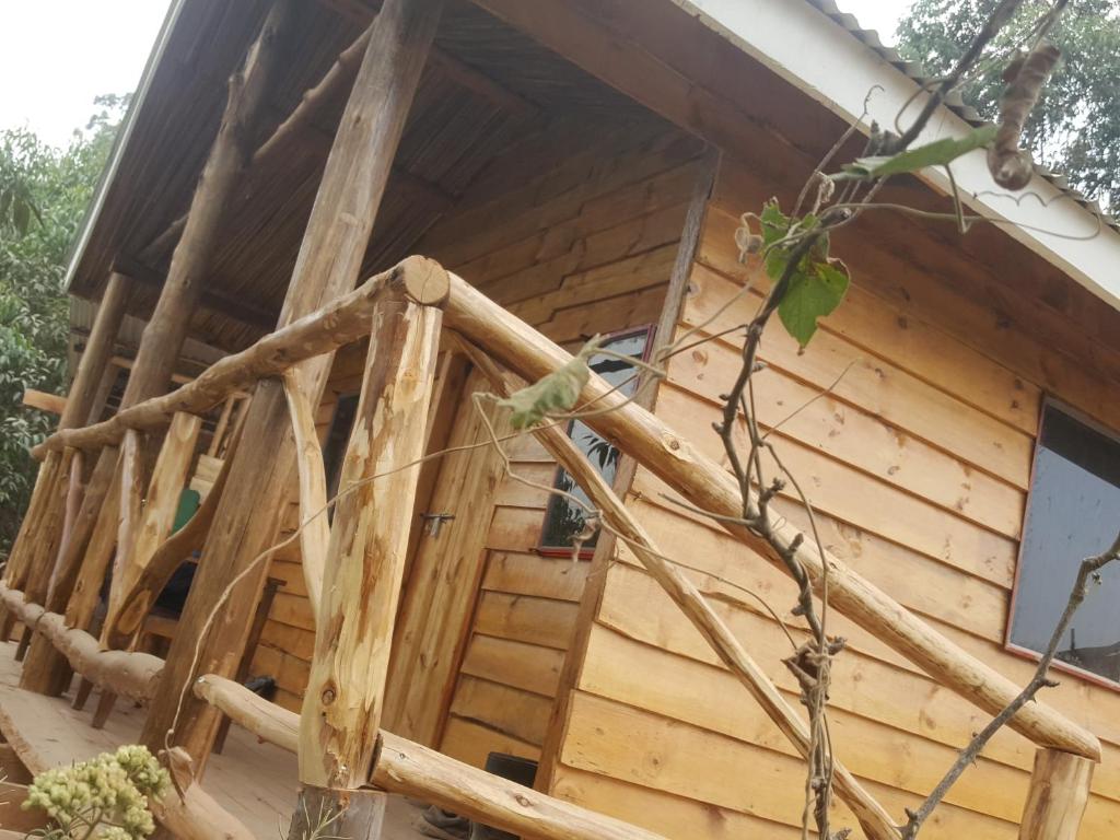 a log cabin with a staircase in front of it at Eagle Peak homestay in Kabale