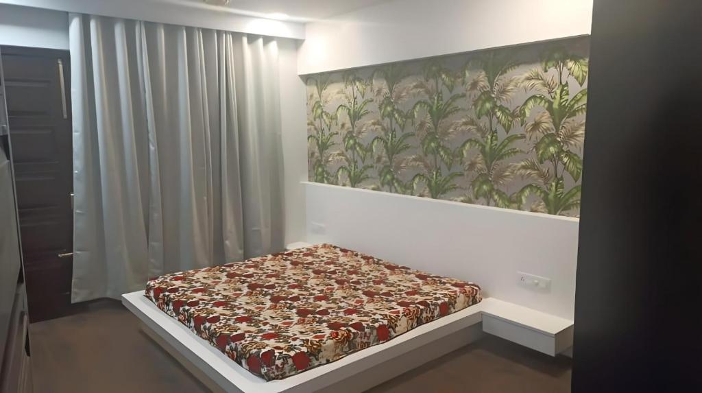 a bed in a room with a painting on the wall at City Beautiful Home One room Suite in Panchkula