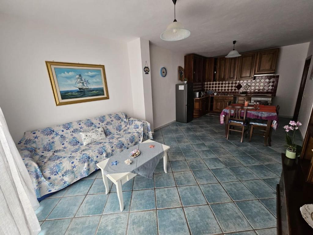 a living room with a couch and a table at Casa Li Conchi in Arzachena