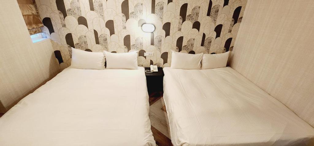 Postel nebo postele na pokoji v ubytování 慶爾喜旅館Goodscompany