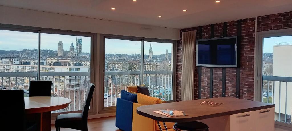 a dining room with a view of a city at Appartement Rouen Ile Lacroix in Rouen