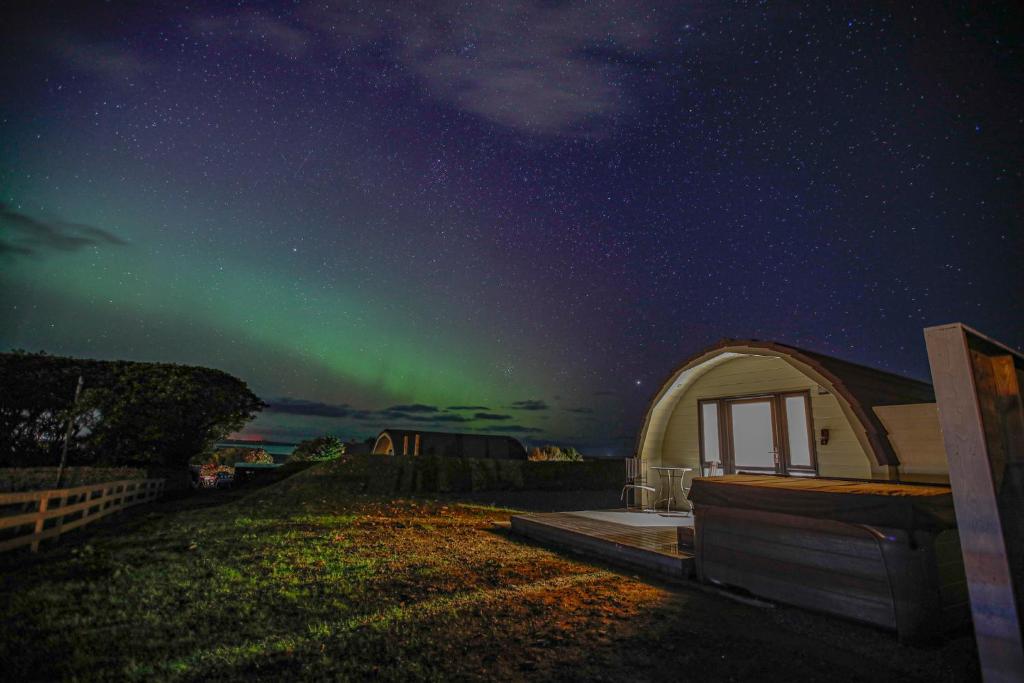 an igloo with the aurora in the sky at Berstane Lodges in Orkney