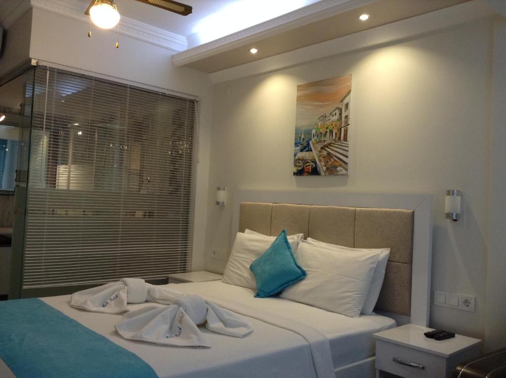 Postel nebo postele na pokoji v ubytování Mola Hotel