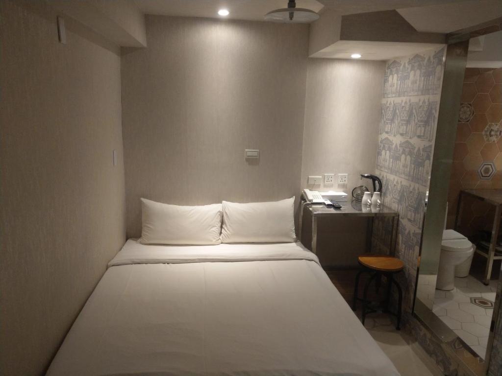 Postel nebo postele na pokoji v ubytování 慶爾喜旅館長沙館Cheers Loft Self Check-in Hotel