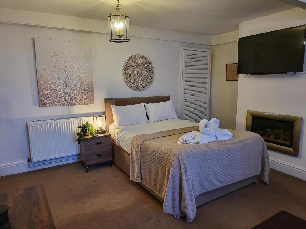 a bedroom with a bed with a towel on it at Seaside Flat with Fast WiFi in Scarborough