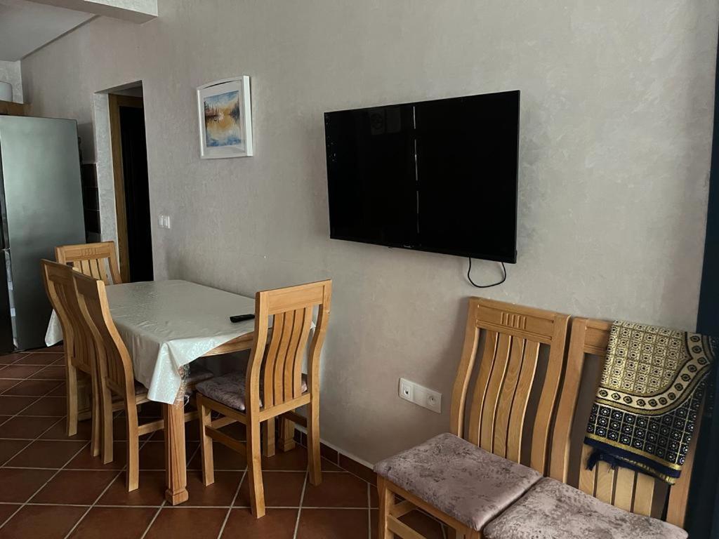 a dining room with a table and chairs and a television on the wall at Luxury resident with pool in Cabo Negro