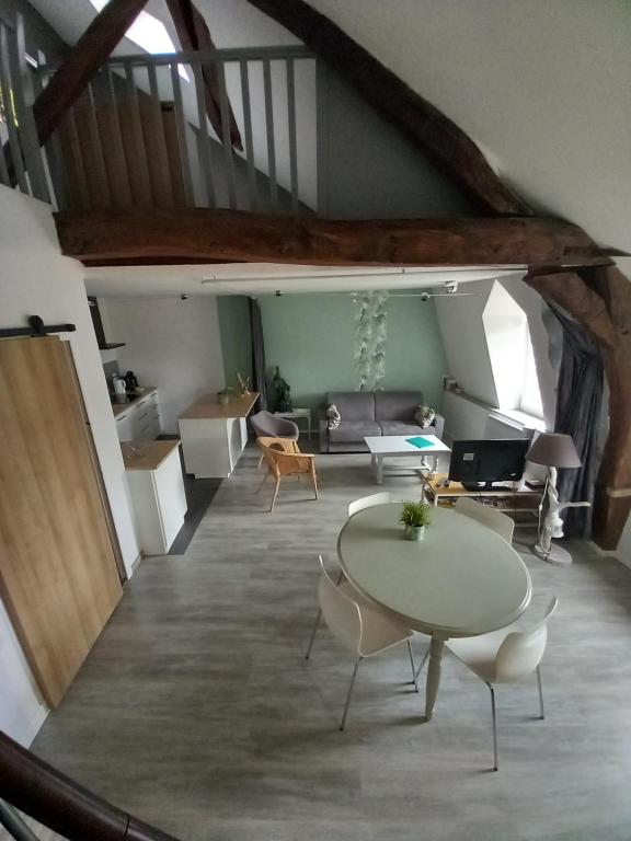 una sala de estar con una mesa y un sofá en Le regard de Mona Lisa 2 étoiles 100m du château, en Amboise