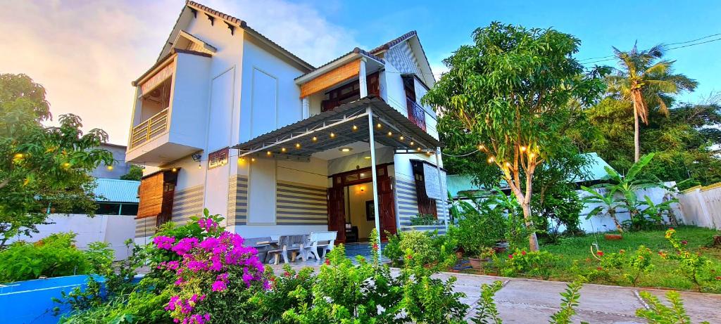 a house with a garden in front of it at Peaceful Villa Seaview - From The Beach 400m in Phan Thiet