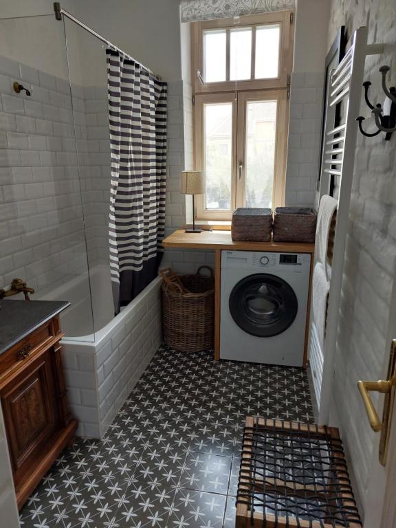 a bathroom with a washing machine and a shower at Belvárosi Kertesház in Keszthely
