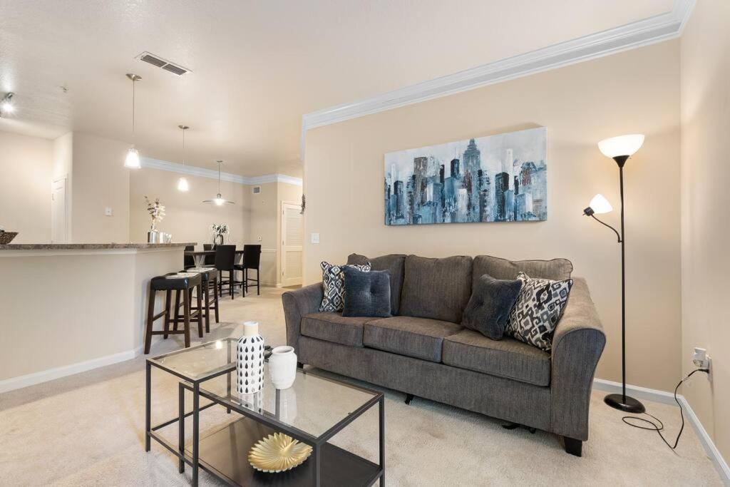 a living room with a couch and a kitchen at Lovely 1-bedroom apartment w/ Pool + Wi-Fi in Charlotte