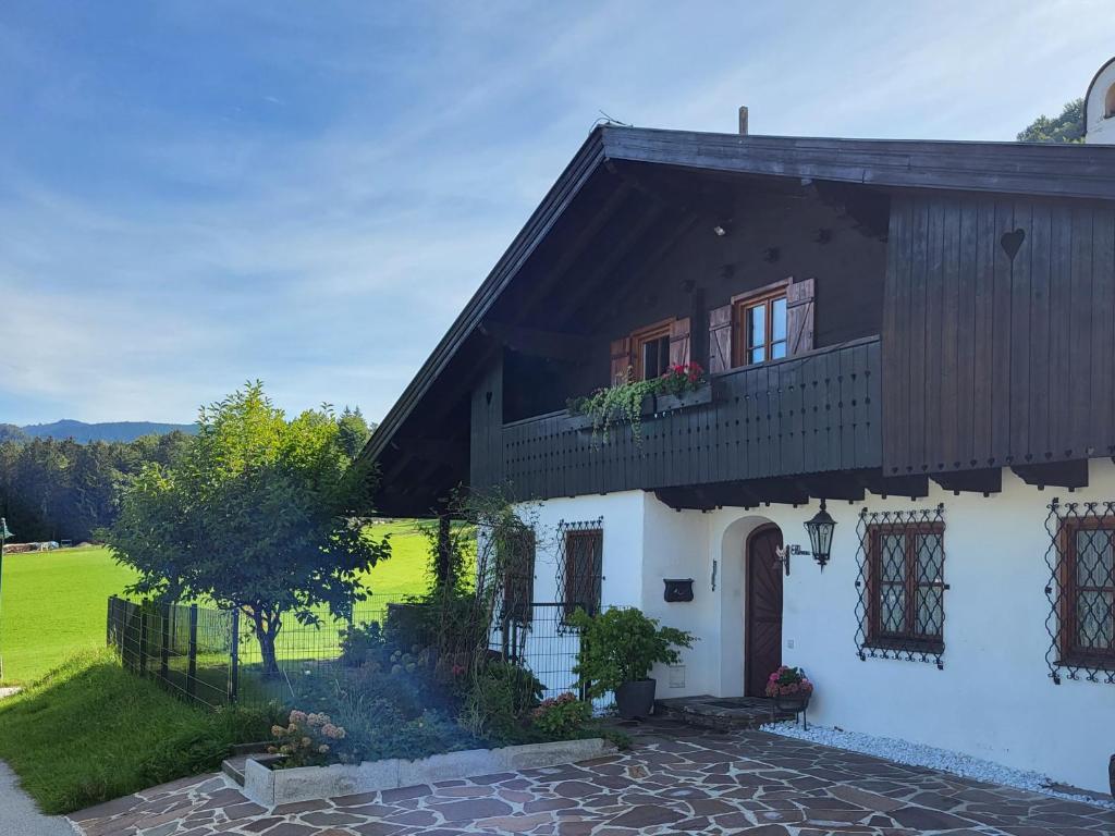 a white house with a black roof at Ferienwohnung am Fuschlsee in Fuschl am See