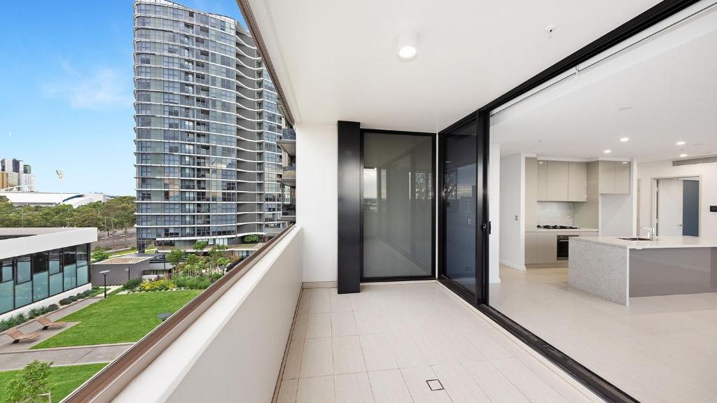 an open balcony with a view of a building at Comfortable Living - NO PARTIES- 3 Bedroom sleeps 6, parking, pool, other amenities - Near Showgrounds in Sydney