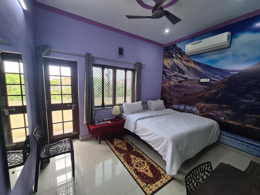 1 dormitorio con 1 cama y una pintura en la pared en Anukampa Paying Guest House en Agra