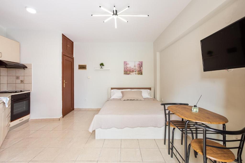 - une chambre blanche avec un lit et une table dans l'établissement Anopolh front apartment, à Thessalonique
