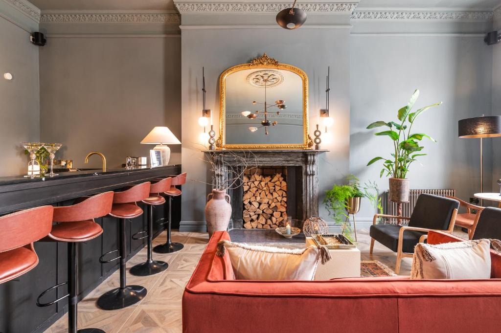 a bar with a fireplace and a red couch at Number 59 - Irish Stay Group in Dublin