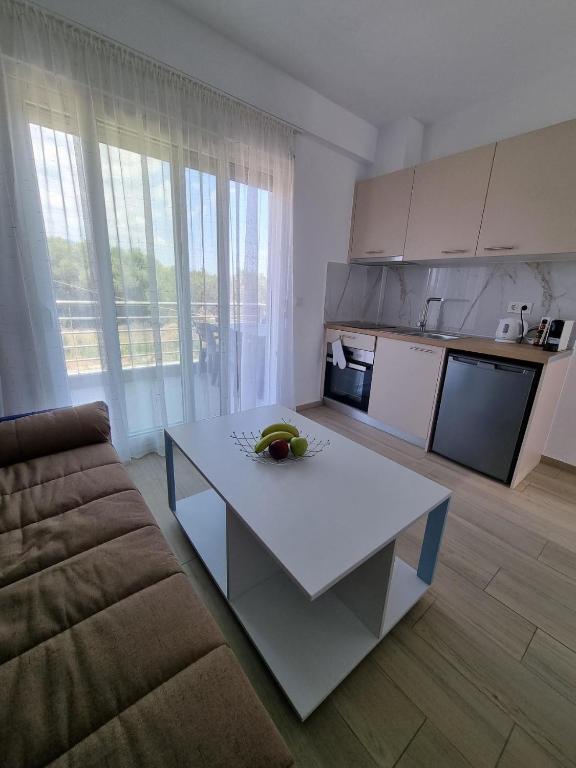 a living room with a white table and a couch at Комплекс Антигони in Ofrínion