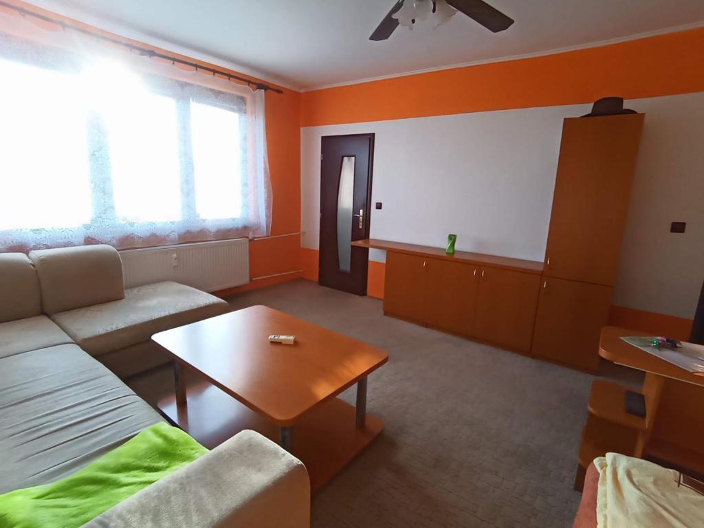 a living room with a couch and a table at WOLF APARTMAN in Považská Bystrica