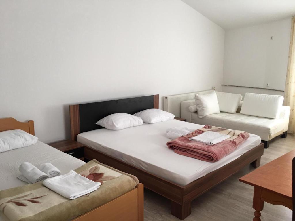 a room with two beds and a couch at Hotel Diplomat in Struga