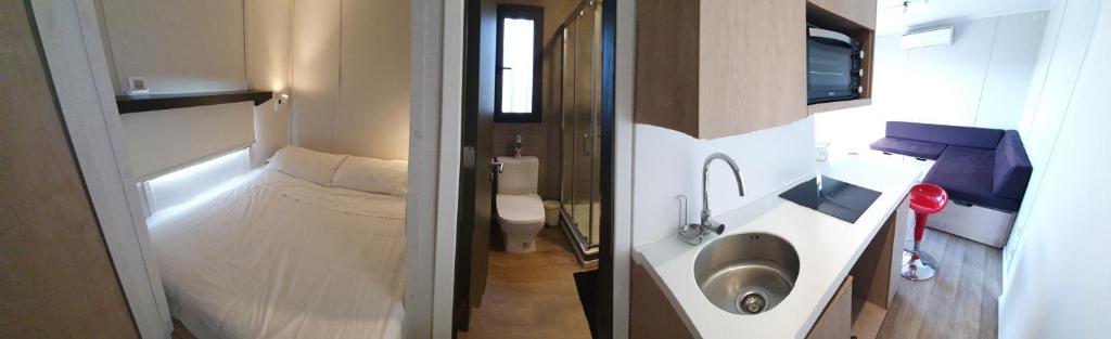 a small bathroom with a sink and a toilet at Cabañas y Padel Tinycolchagua cl in Santa Cruz