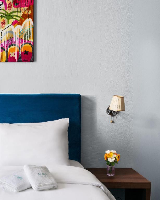 Postel nebo postele na pokoji v ubytování Alma Boutique Hotel