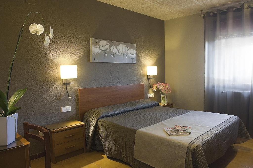 Postel nebo postele na pokoji v ubytování Hostal Barris